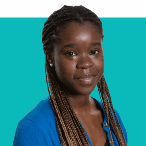 Jenzy's headshot. She is wearing a royal blue top and is in front of a teal background
