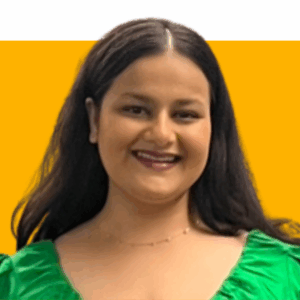 Mahek Zaveri headshot on an orange and white background.